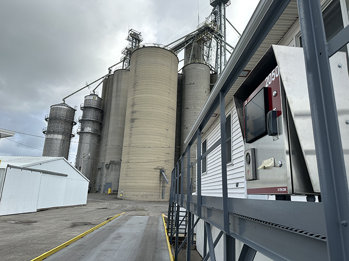 BTEK truck scale and kiosk are shown in the foreground while silos stand tall in the background