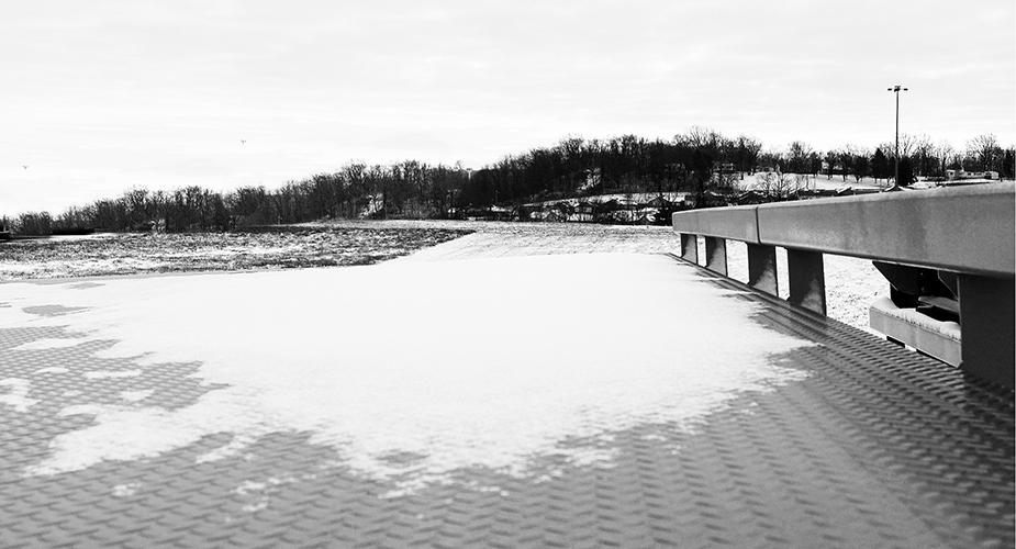 Snow partially covers a steel truck scale